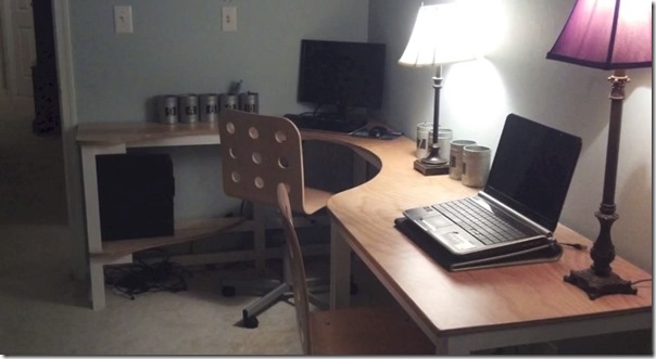 Large corner plywood desk installed in a bedroom