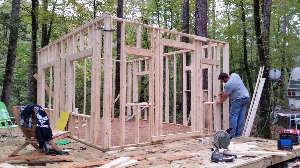 Family helping frame the cabin walls