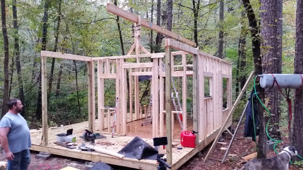 Main roof beam set in place on a rainy day