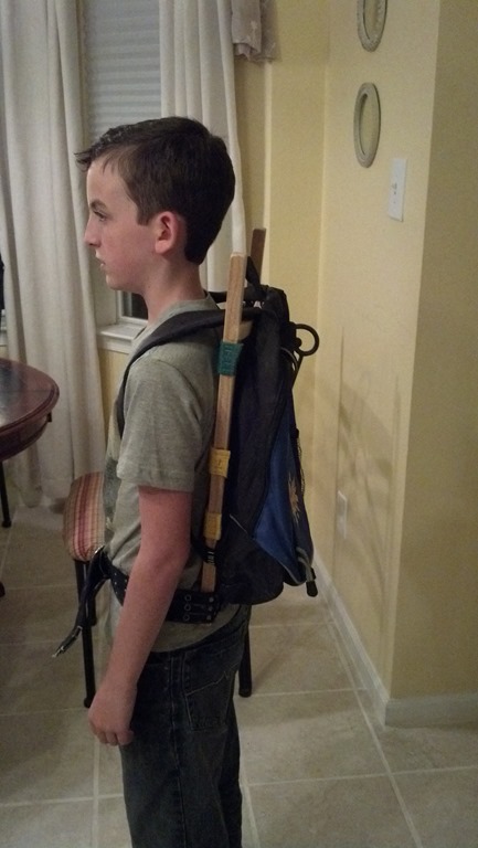 Small backpack attached directly to a wooden pack frame